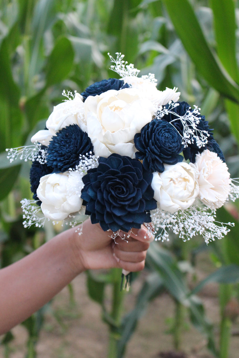 wedding flowers with navy blue dresses Navy blue is always a timeless and classic choice for bridesmaid dresses! This wedding party looked absolutely incredible in our bowed one-shoulder trumpet gown in midnight navy. Style #Dessy6769 Color #DessyMidnightNavy Fabric #